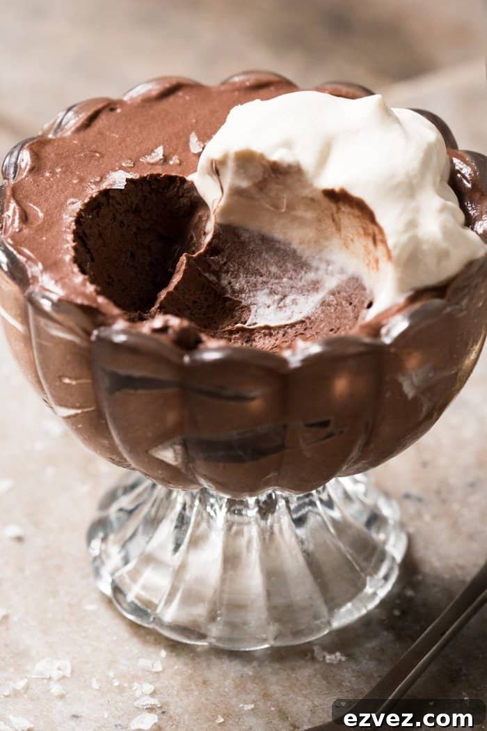 Keto chocolate mousse with whipped cream in a serving glass