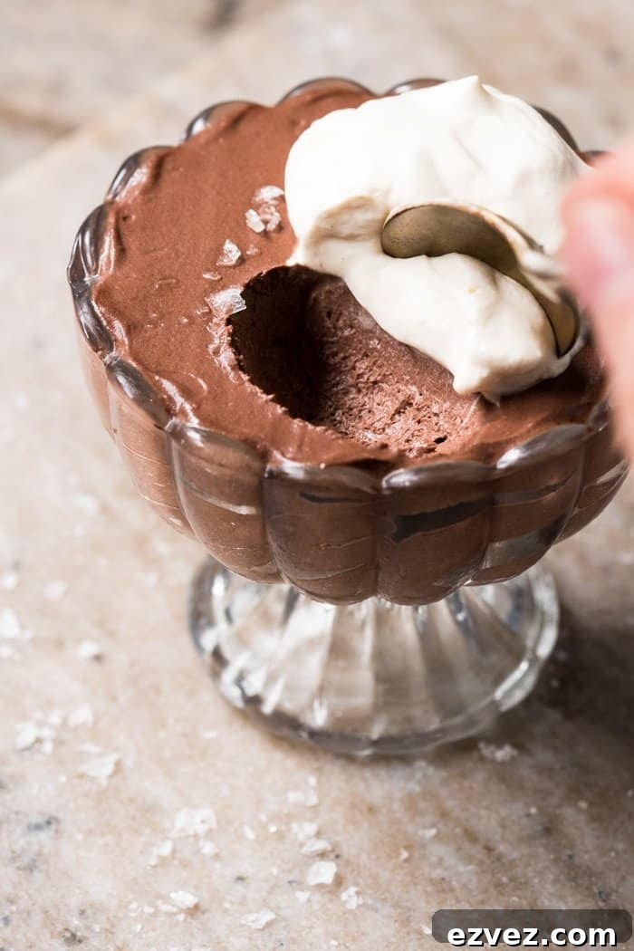 Taking a spoonful of keto chocolate mousse