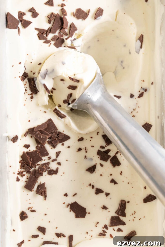 Scooping no-churn mint ice cream out of a pan