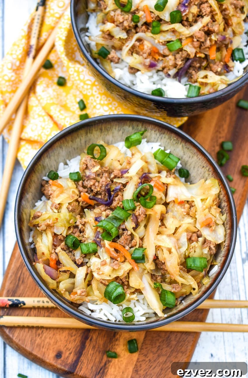 instant pot egg roll in a bowl sitting on a wooden cutting board with chop sticks on the side