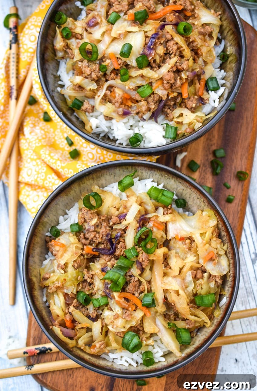 instant pot egg roll in a bowl sitting on a wooden cutting board with chop sticks on the side