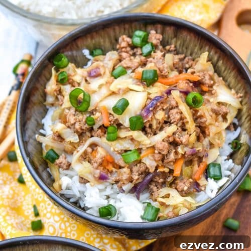 instant pot egg roll in a bowl sitting on a wooden cutting board with chop sticks on the side
