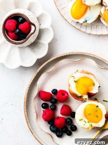 Prosciutto Egg Cups on a plate with fruit