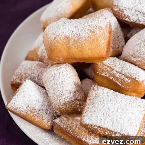 Mardi Gras means it's time for beignets! This is a classic New Orleans recipe, deep-fried then coated in powdered sugar, and served with raspberry jam.