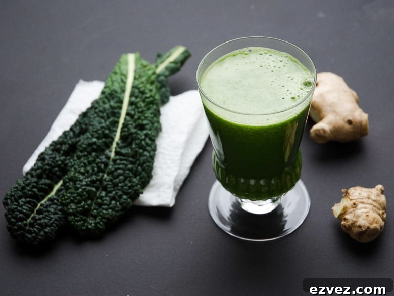 Kale Juice Benefits, Recipes, and How to Make It at Home 5 Kale juice in a glass with kale leaves and ginger