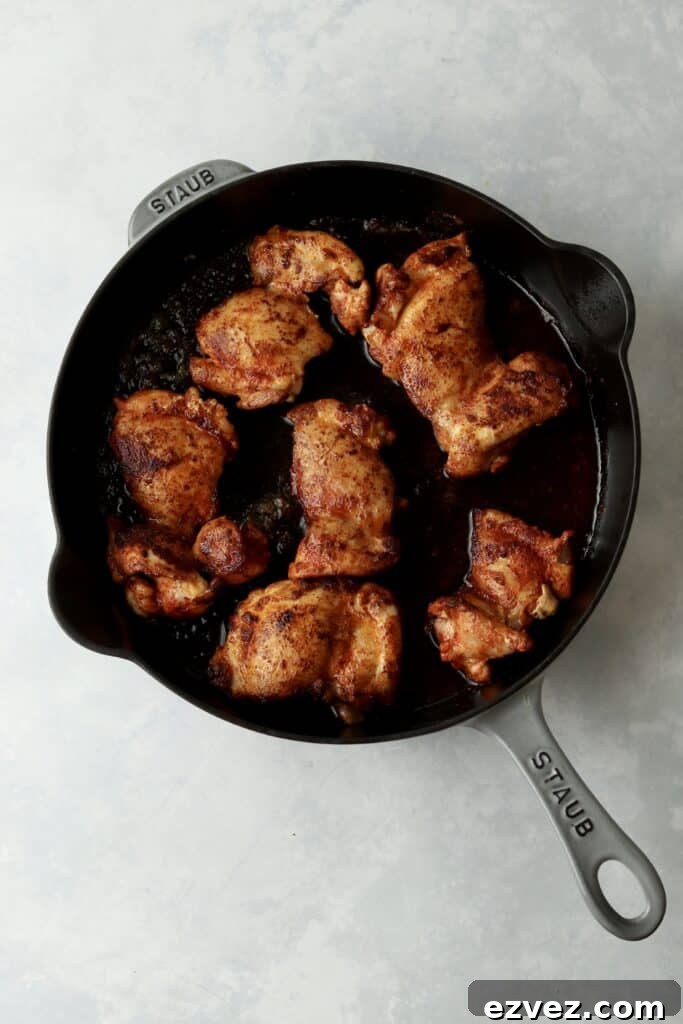 Creamy Chicken Gnocchi with Spinach and Parmesan 5 browned chicken thighs in cast iron skillet