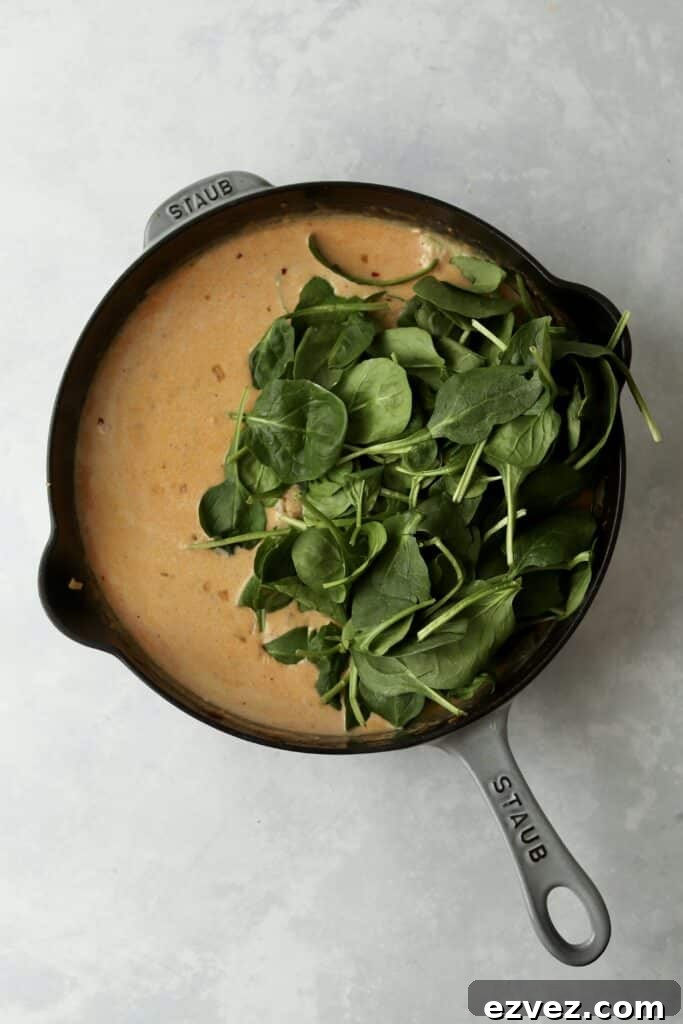 Creamy Chicken Gnocchi with Spinach and Parmesan 7 cream sauce with spinach in cast iron skillet