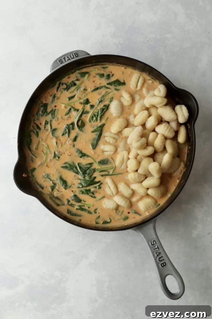 Creamy Chicken Gnocchi with Spinach and Parmesan 8 cream sauce with spinach and gnocchi in cast iron skillet