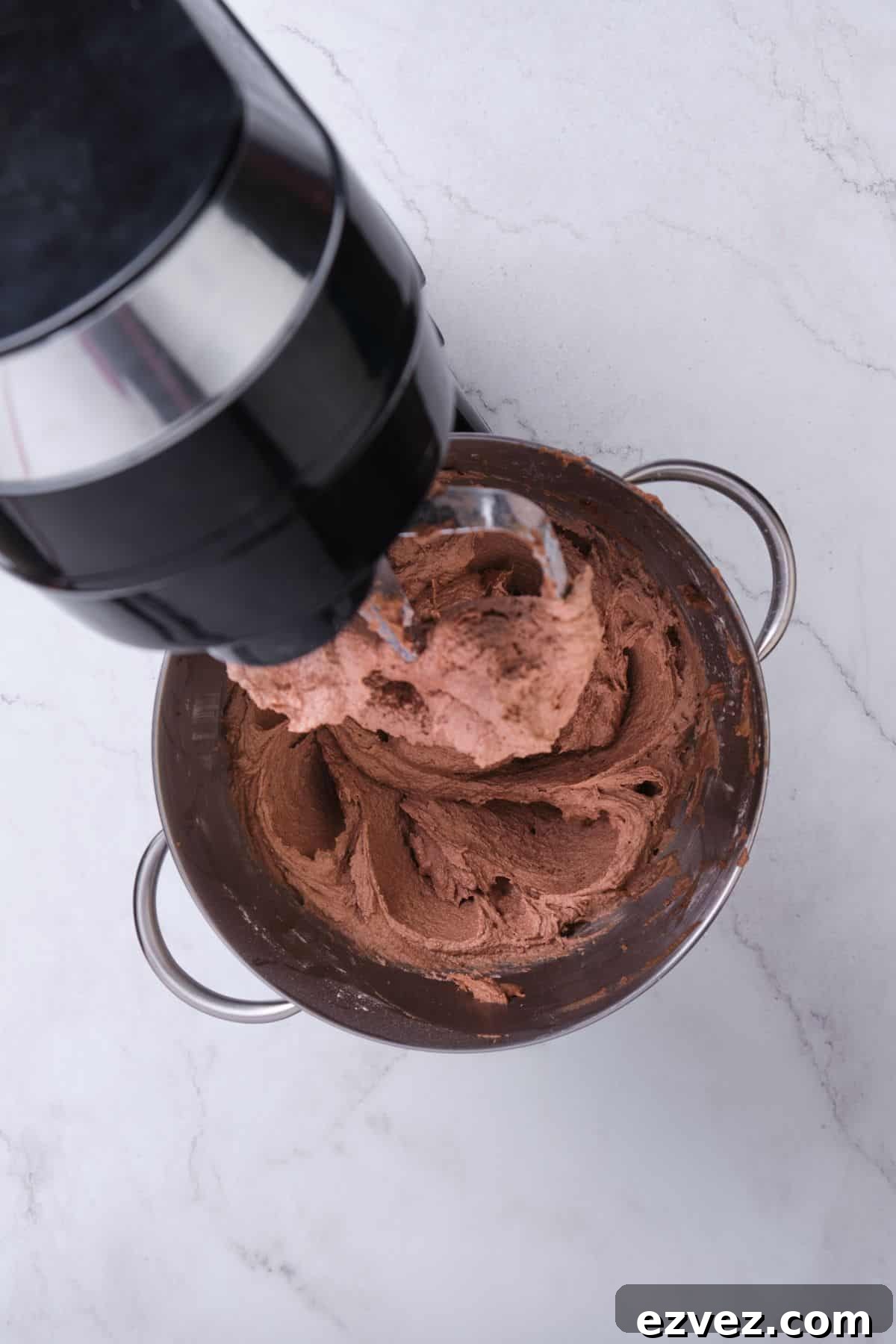 Chocolate buttercream in a stand mixer.