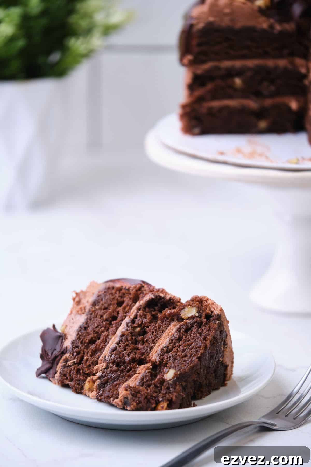 A slice of chocolate walnut cake on a plate.