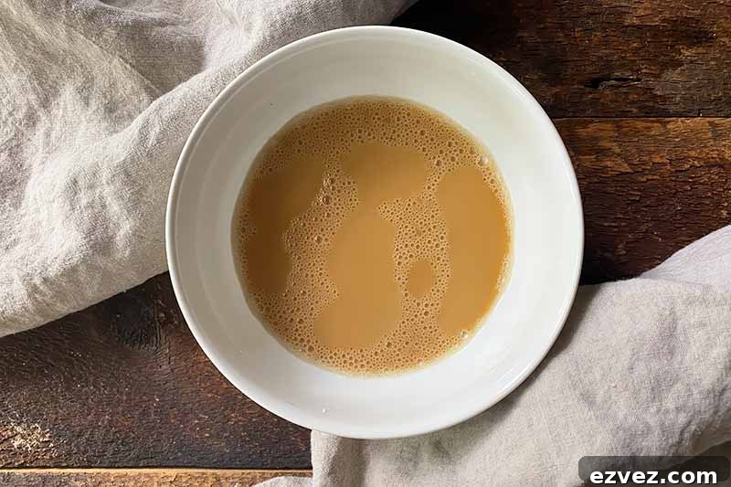 Leftover Pot Roast Mushroom Soup Recipe for Comforting Meals 12 Horizontal image of a light brown slurry in a white bowl.