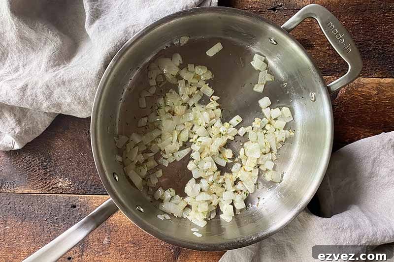 Leftover Pot Roast Mushroom Soup Recipe for Comforting Meals 9 Horizontal image of cooking diced onions in oil in a pot.