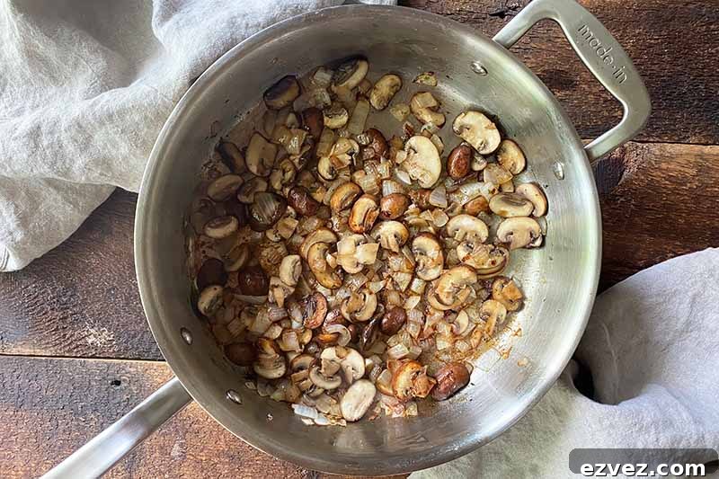 Leftover Pot Roast Mushroom Soup Recipe for Comforting Meals 10 Horizontal image of cooking sliced mushrooms in a pot.