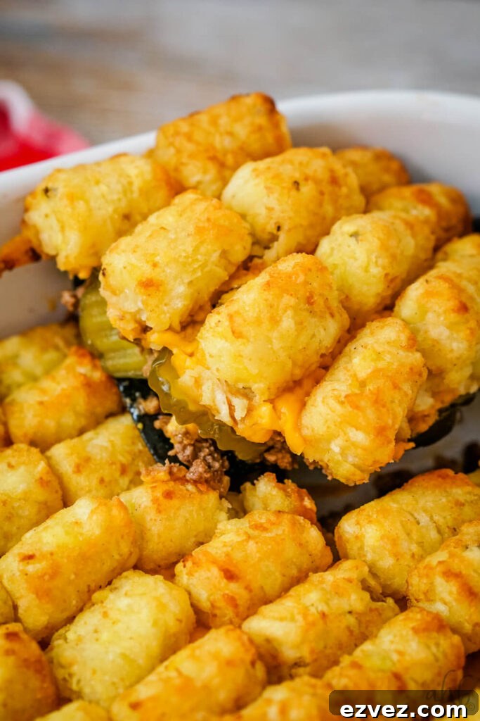 Big Mac Tater Tot Casserole Recipe: Cheesy Beef & Tots Bake 11 Big Mac Tater Tot casserole is scooped out of the baking dish with a black spatula.