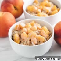 Two bowls of oatmeal topped with fresh peaches.