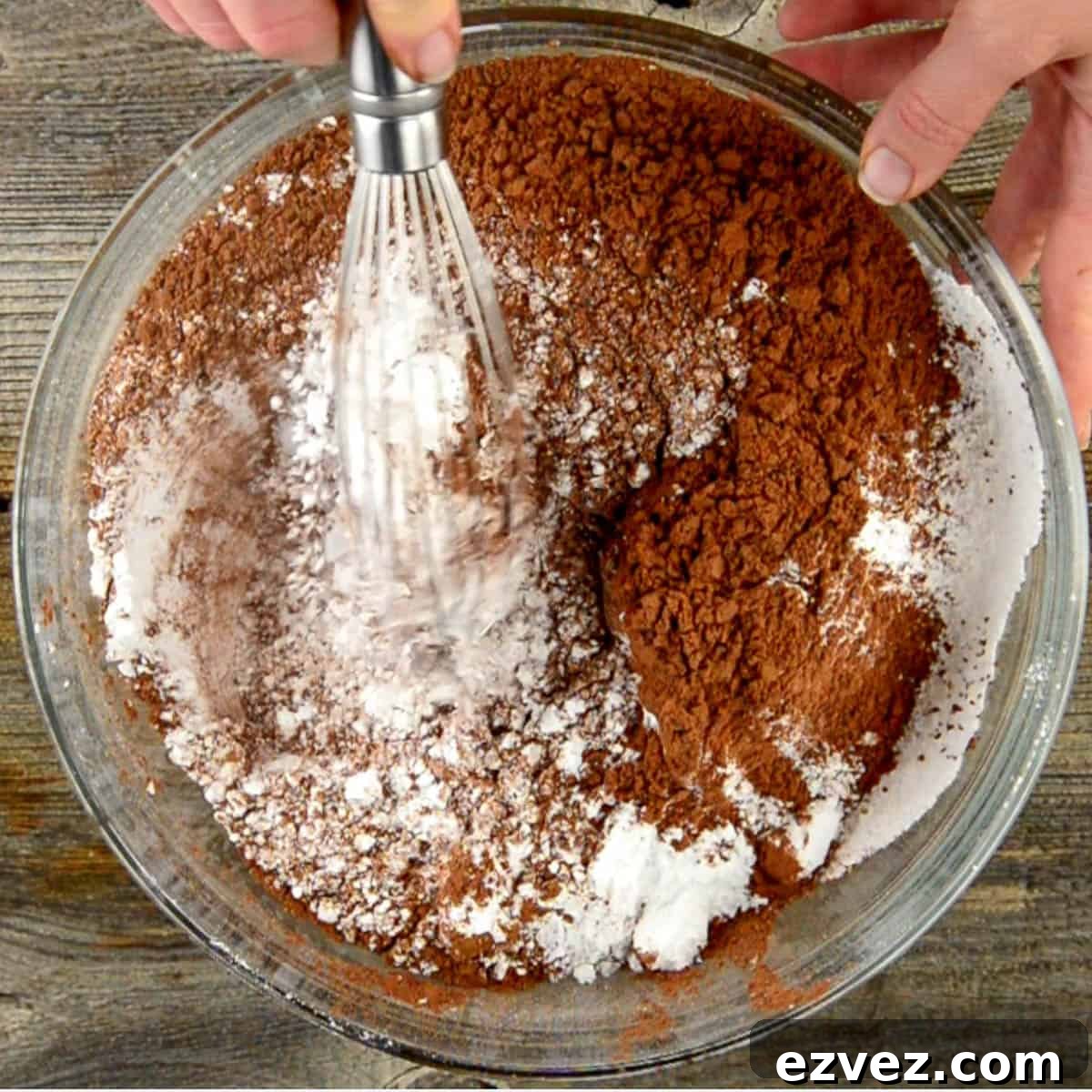 mixing cocoa powder and powdered sugar in glass bowl.