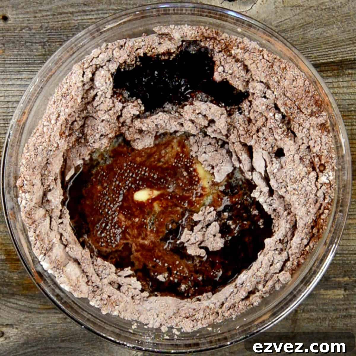melted butter mixed with cocoa powder and sugar for fudge recipe.