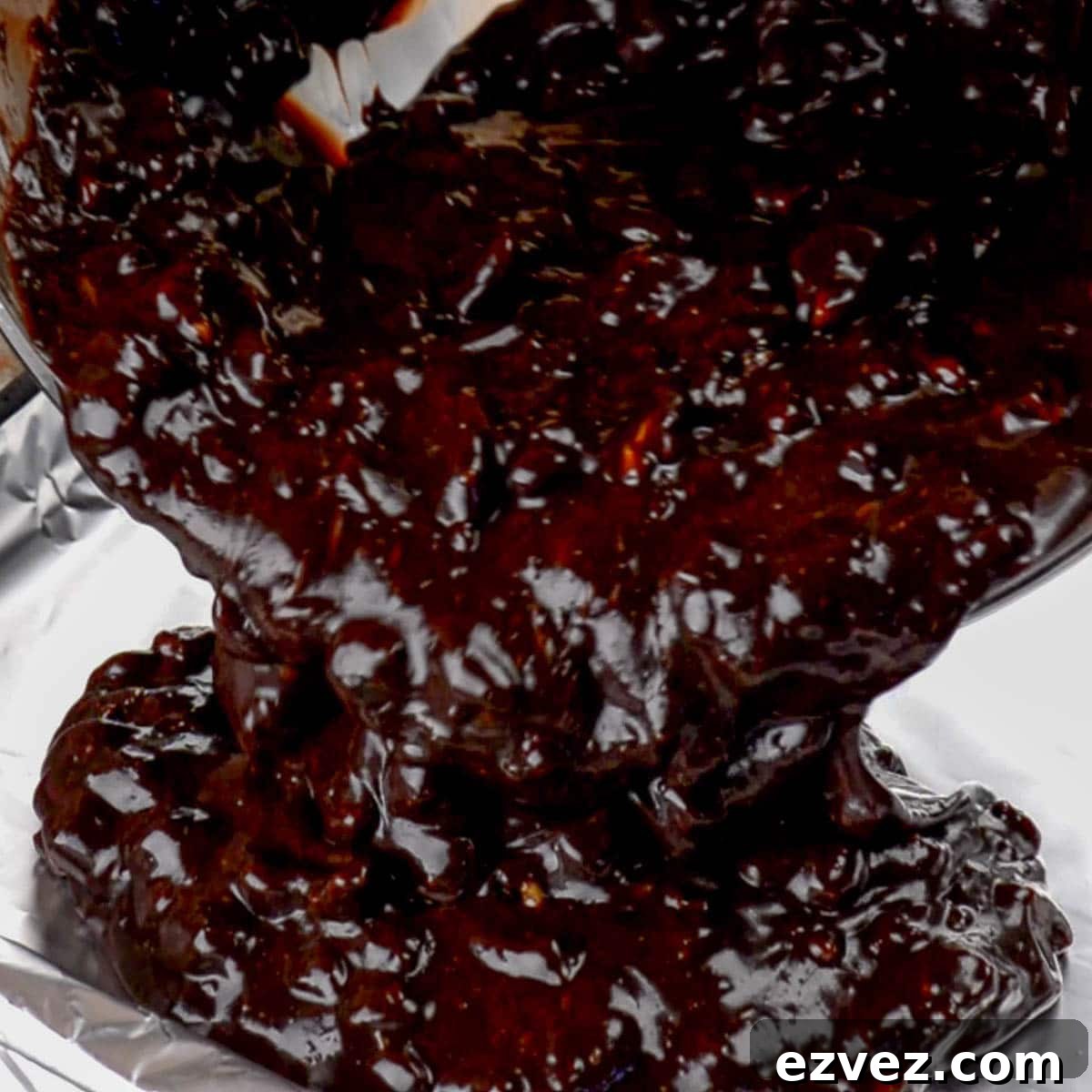 Pouring melted fudge into pan to set.