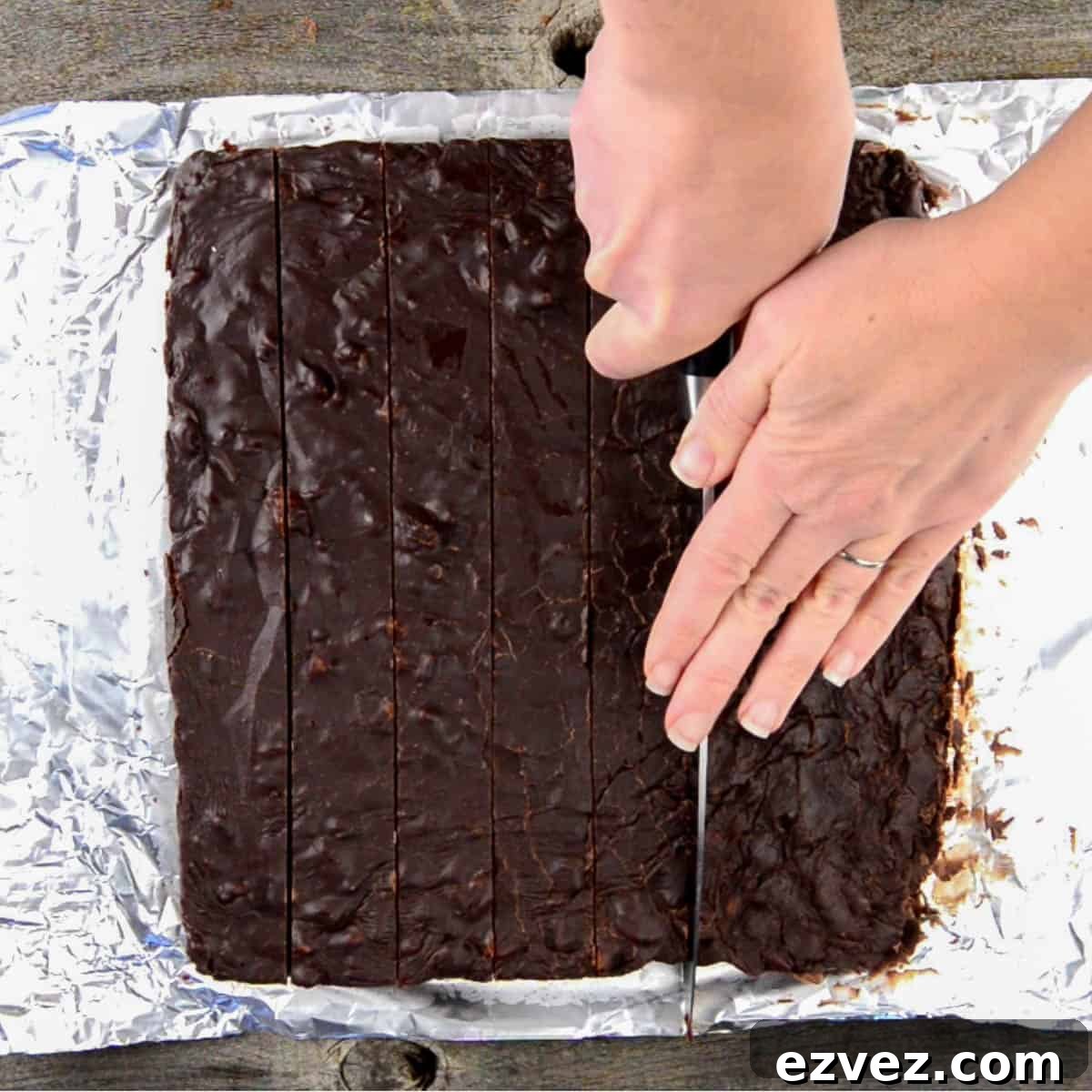 Cutting homemade chocolate fudge into squares.