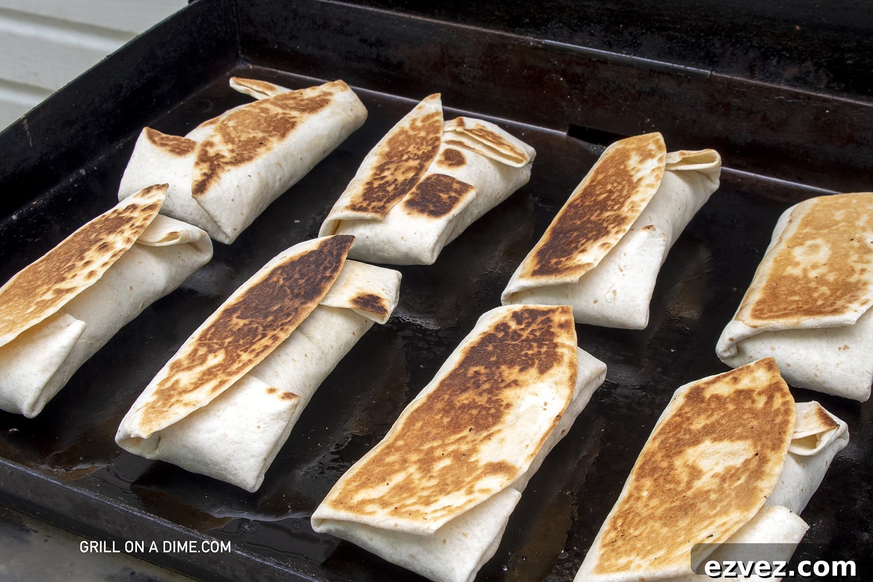 Breakfast burritos with a golden texture on the griddle