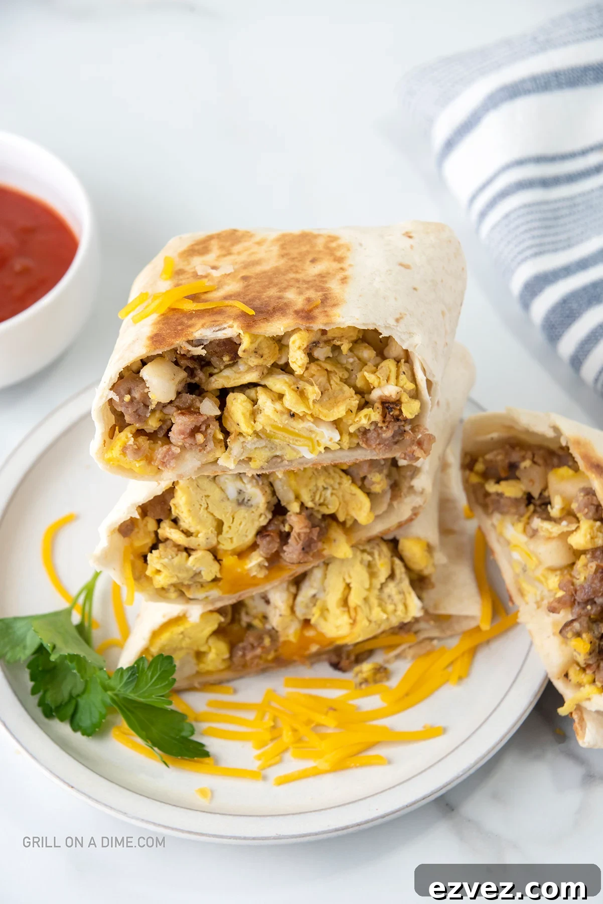 Breakfast Burritos cut in half and stacked on a plate