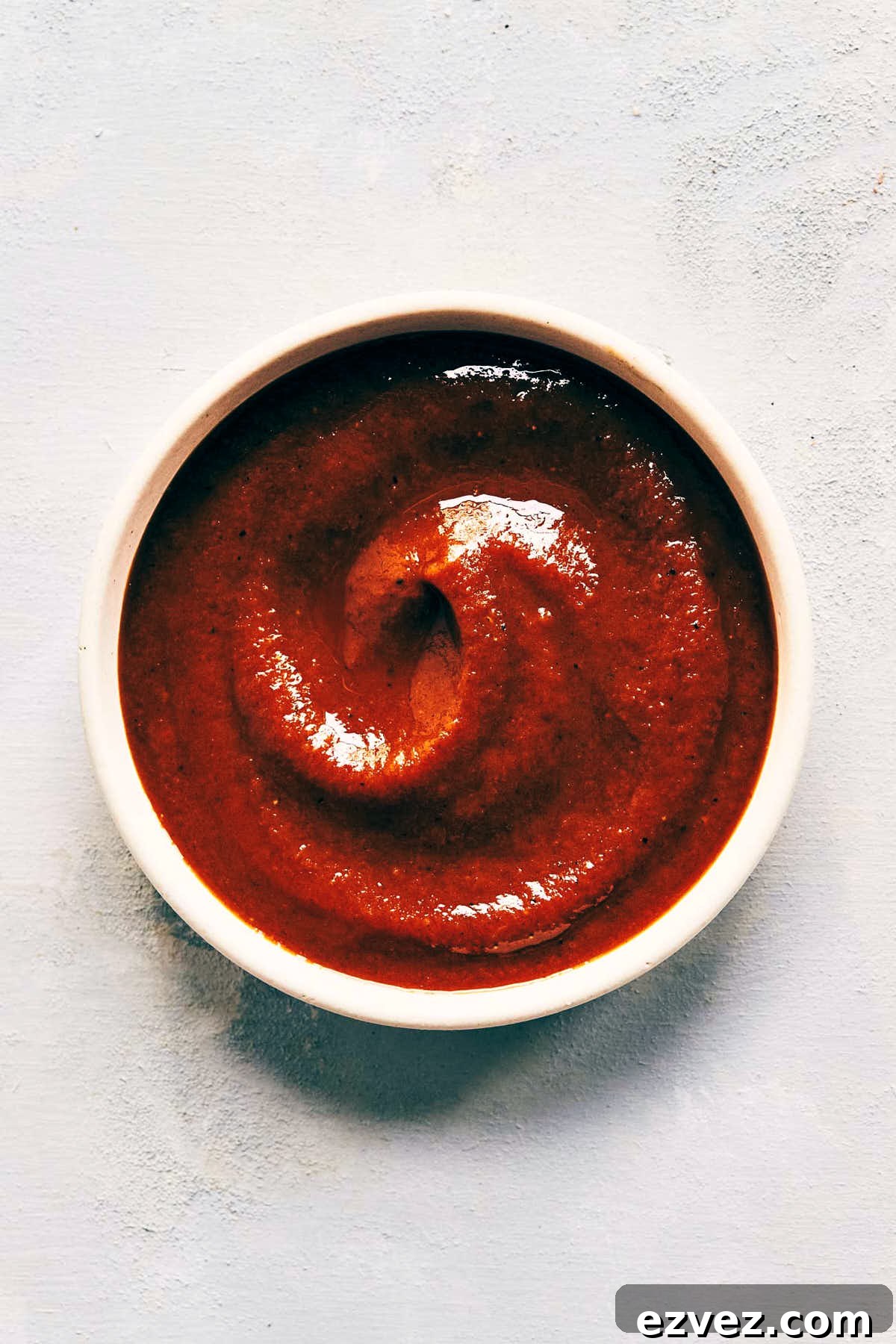 Close up on bowl of homemade barbecue sauce after it has been used