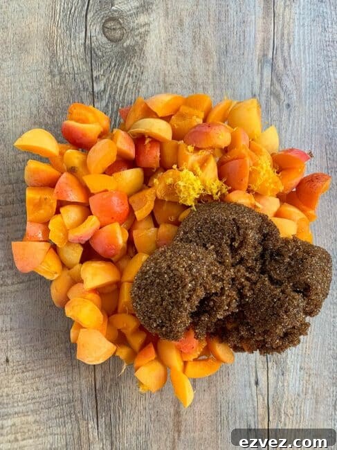 Brown sugar, apricots, lemon juice and zest in a clear glass bowl.