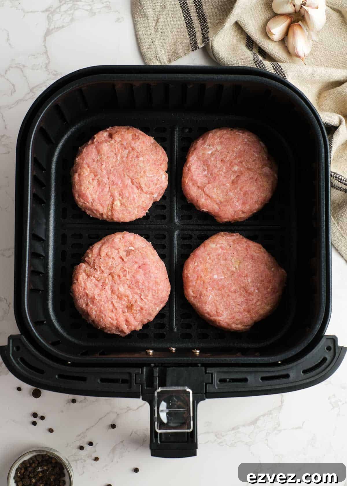 four turkey burger patties in an air fryer
