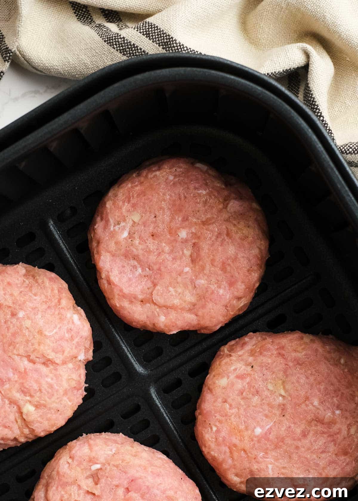 raw turkey burger patties in an air fryer