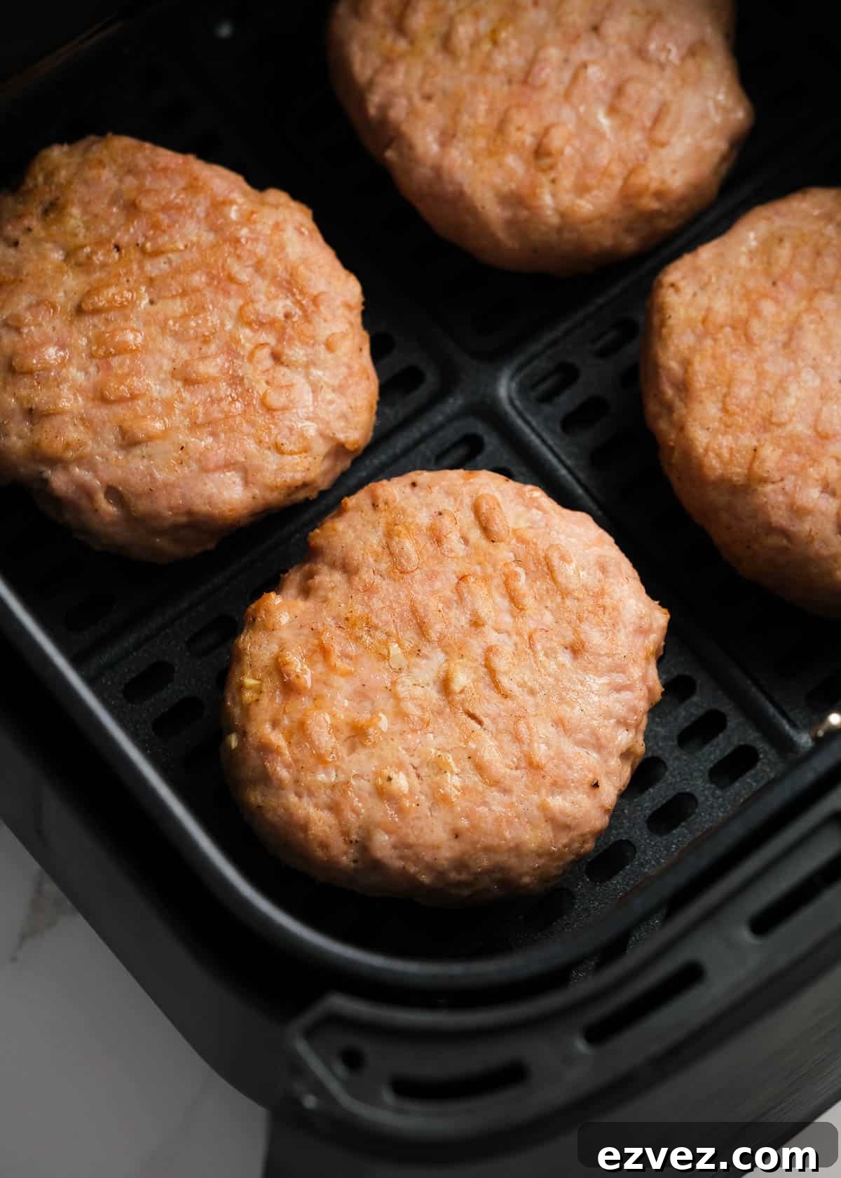 cooked turkey burgers in the air fryer basket