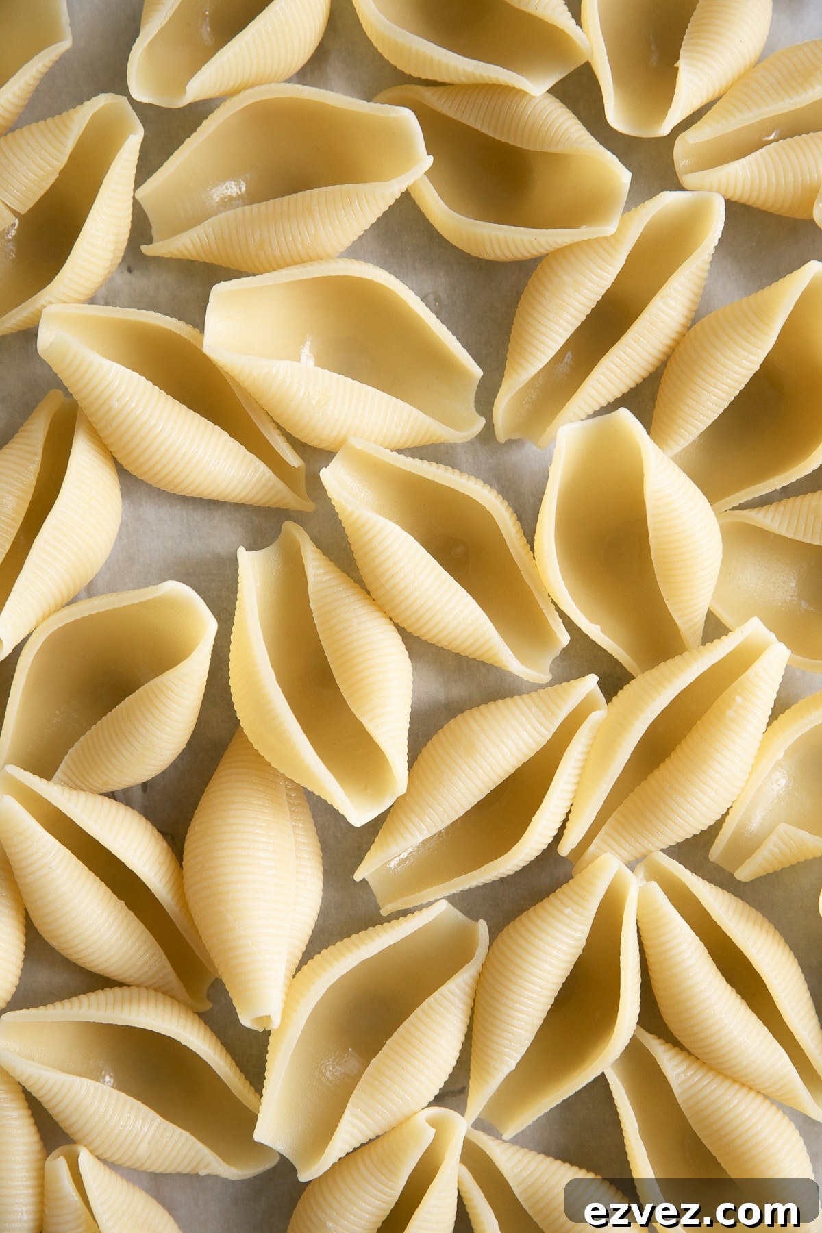 Baked Ricotta Stuffed Shells with Marinara 4 Al dente pasta shells on a large baking sheet lined with parchment paper.