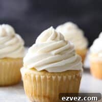 The fluffiest and creamiest vanilla frosting, piled on a cupcake