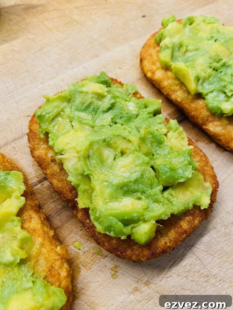 adding avocado to make Spicy Crab Roll Hash Browns