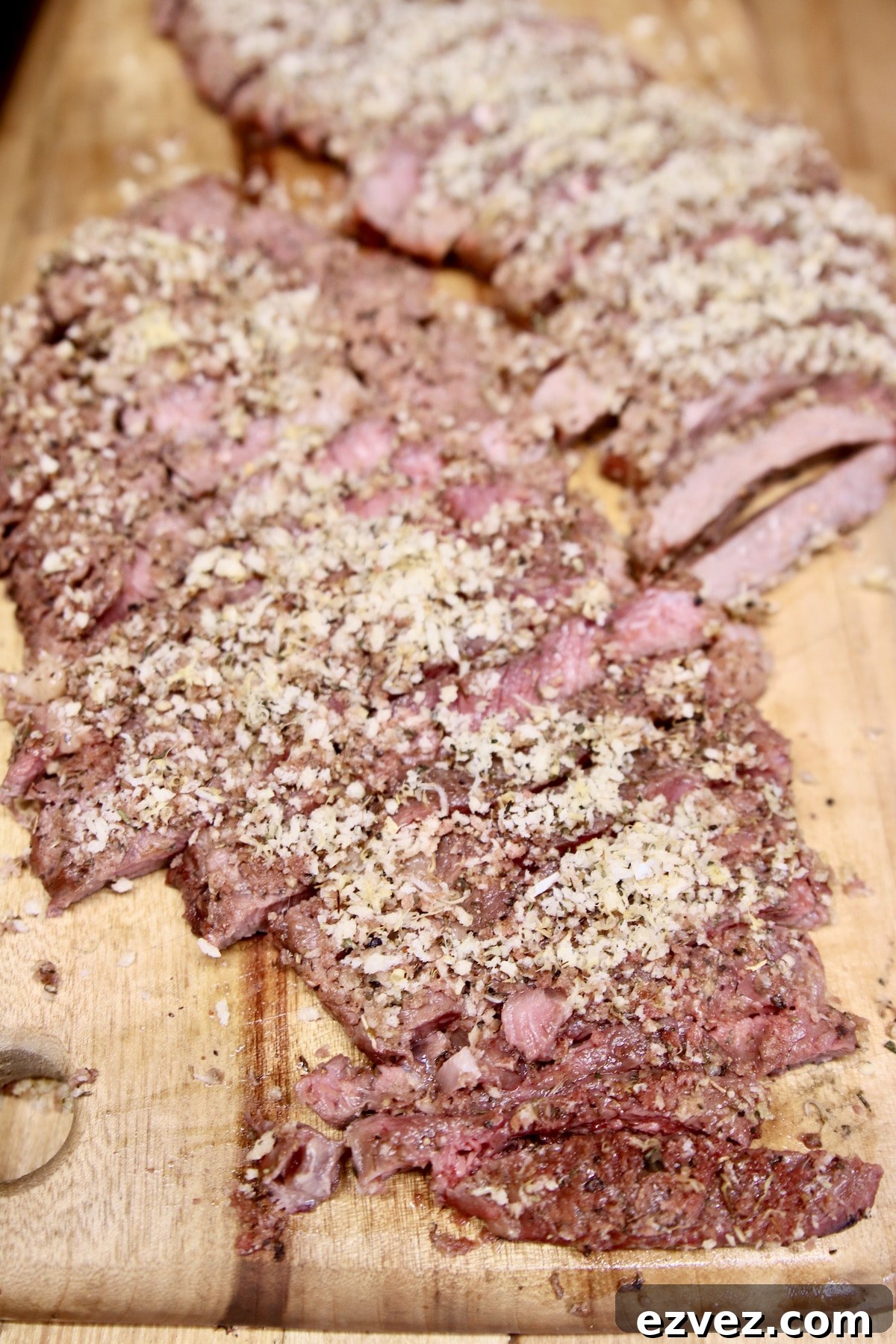 Sliced steak on a cutting board.