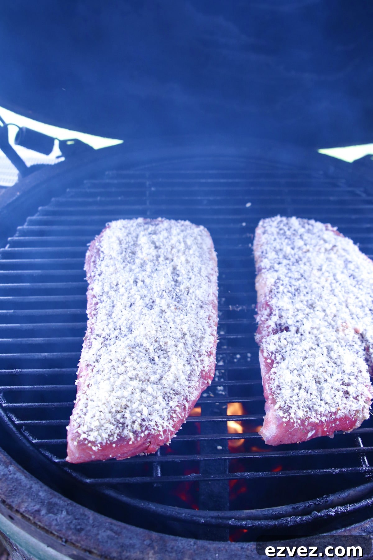 Parmesan crusted steak on a grill.