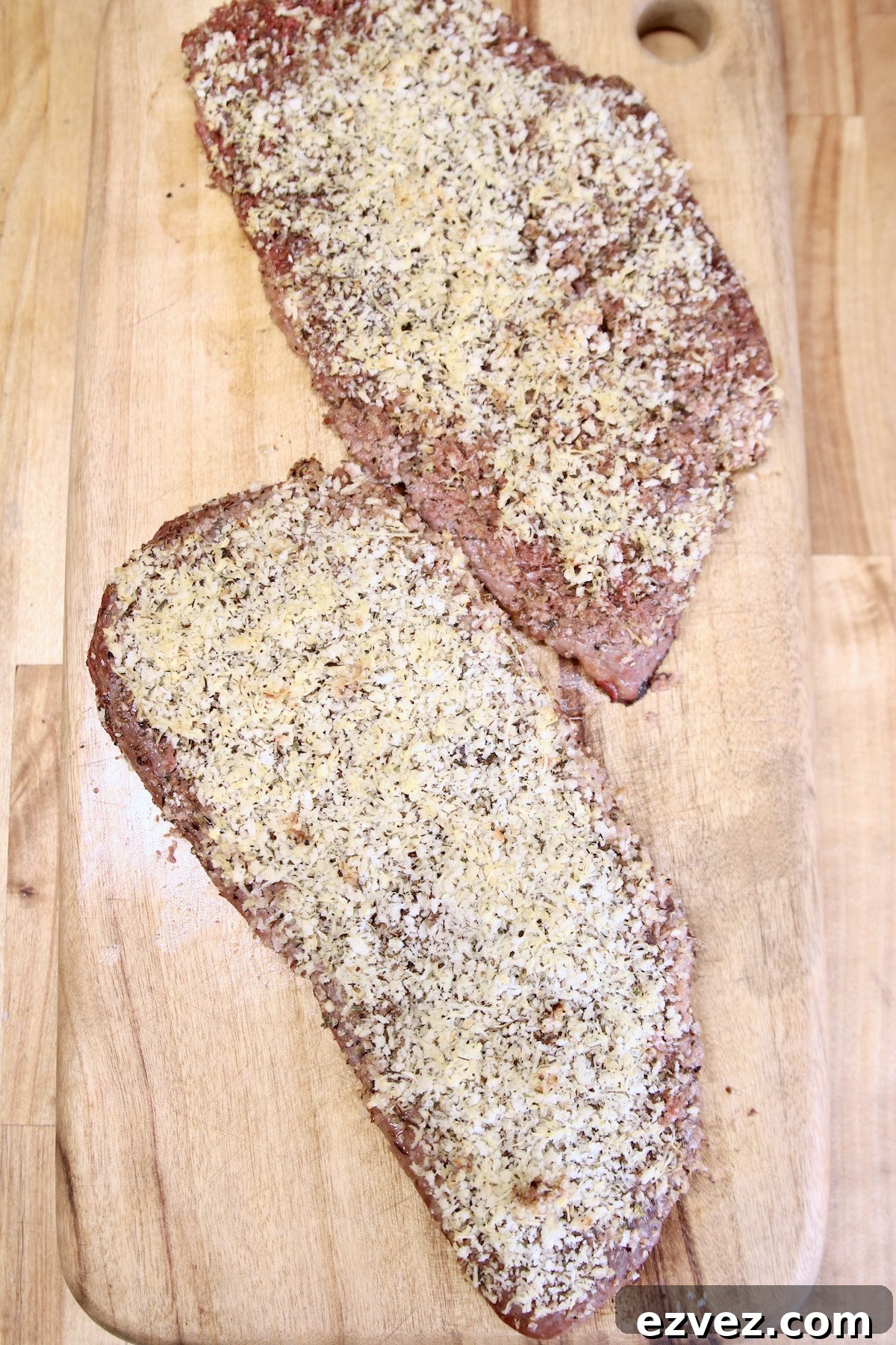 Grilled sirloin steaks resting on cutting board.