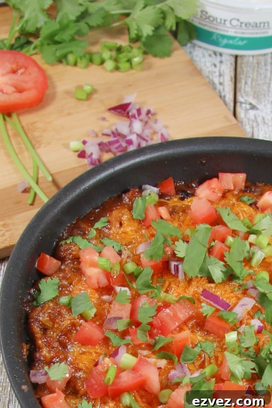 A delicious appetizer made with ground beef, black beans, and fresh veggies.